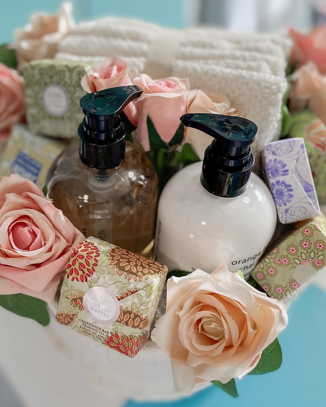 A spa gift basket with soaps, lotions, and roses