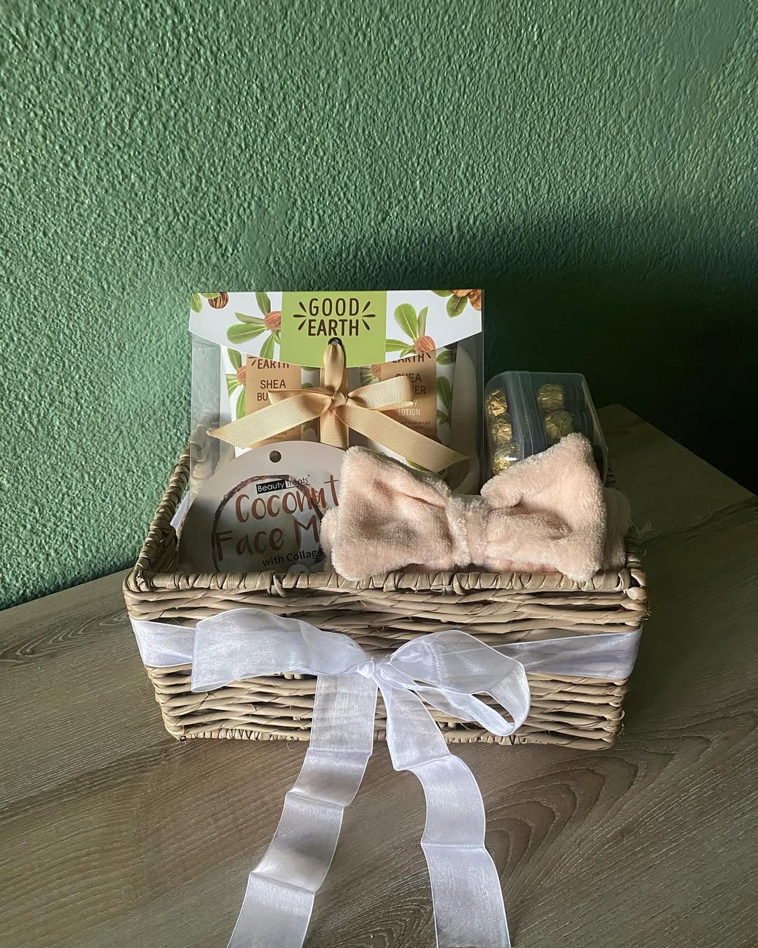 A pamper gift basket with skincare, chocolates, and a soft headband