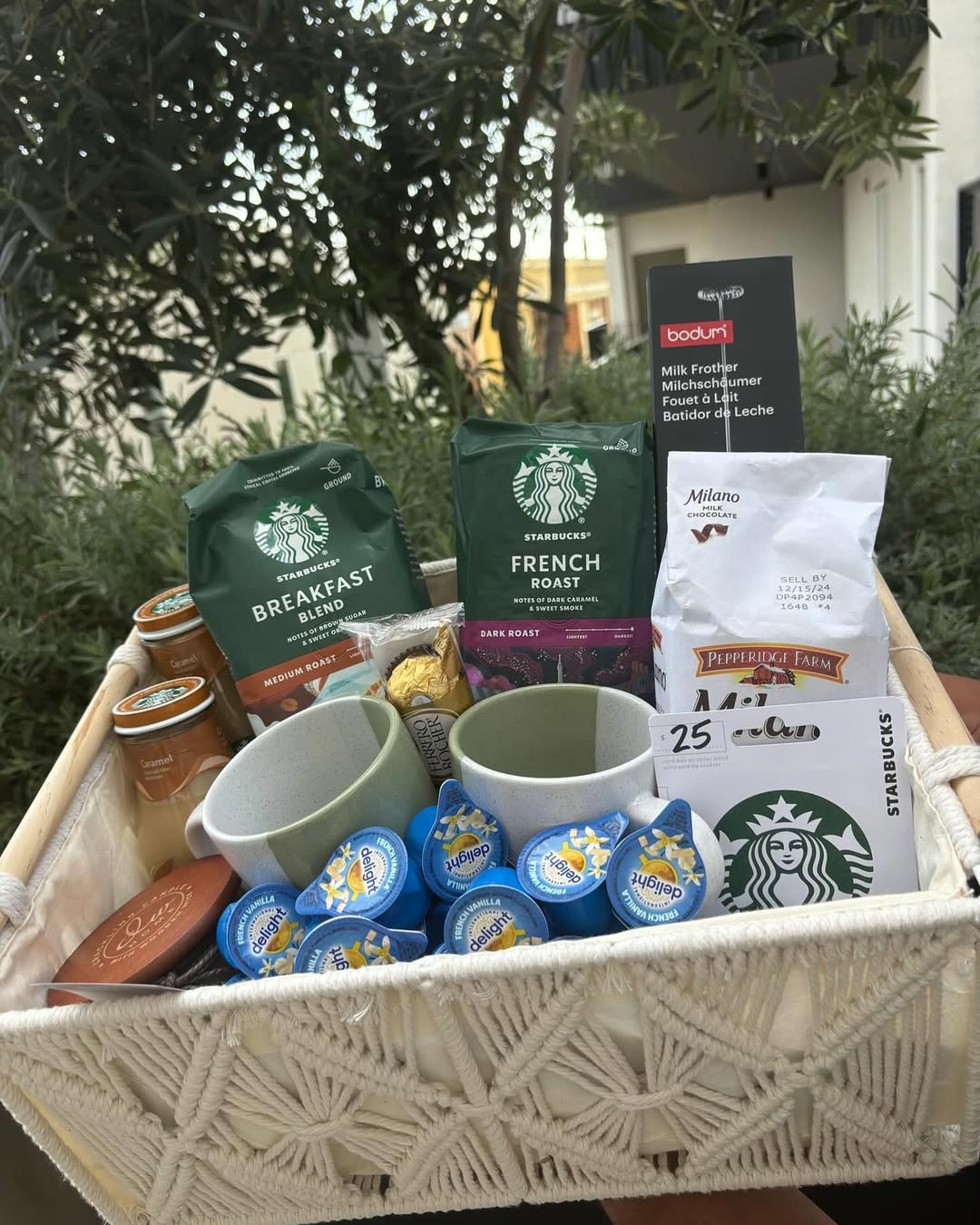A coffee lover’s basket filled with Starbucks blends, mugs, creamers, and treats.