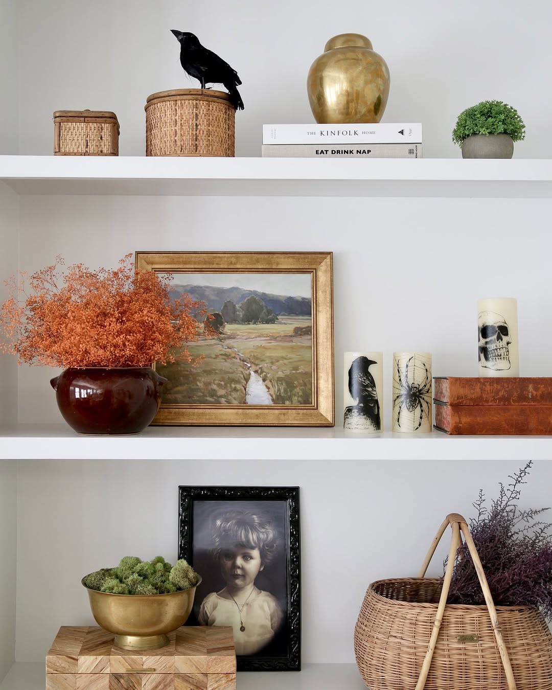 Shelves mix books, baskets, art, and bold accents for balance.