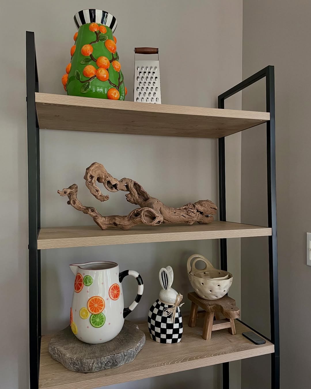 Playful shelves with colorful ceramics and natural wood