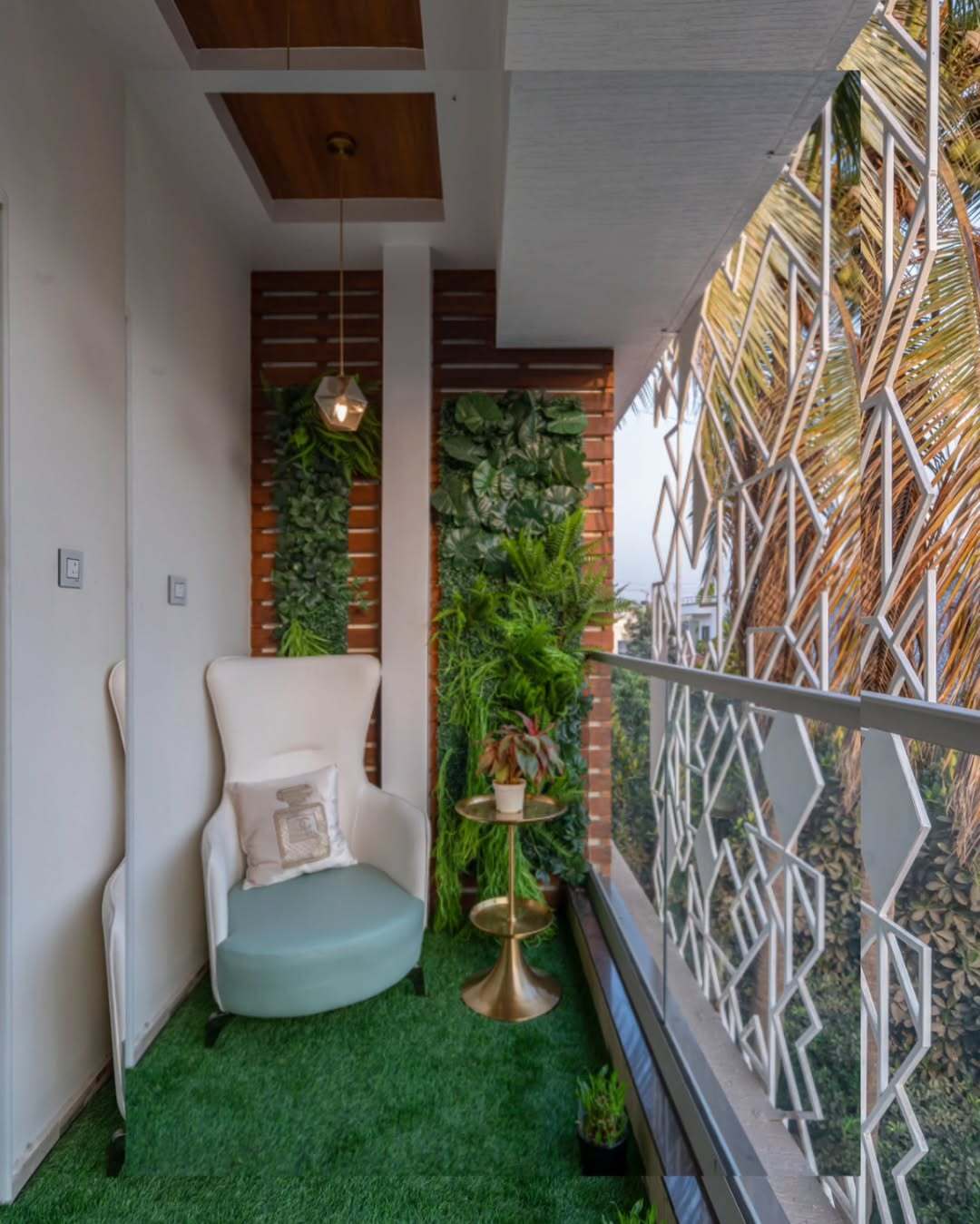 The vertical garden, pendant light, and chic furniture create a luxurious yet refreshing vibe